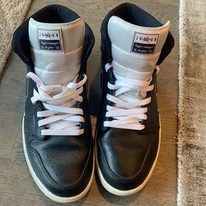 Black leather Jordan 1 Mids, men’s size 11. With “destroyed the game 1985”